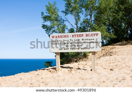 Warning sign about the steep bluff at Sleeping Bear Dunes National Lakeshore on Lake Michigan