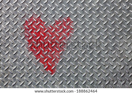 Landscape oriented photo of heart painted on metal with a diamond cut pattern. Sidewalk in Capital Hill, Seattle, Washington