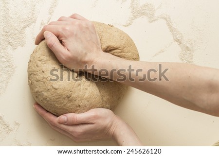 Woman hands knead dough