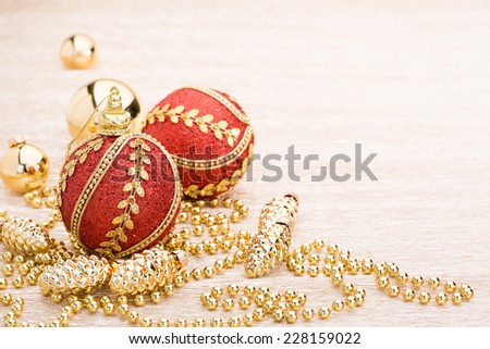 Red and gold christmas ball on illuminated background