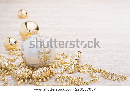 White and gold christmas ball on illuminated background