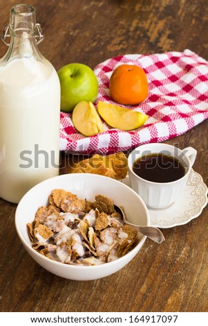 Healthy breakfast with granola, fresh fruits, nuts and milk.