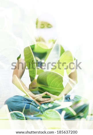 Double exposure photograph of meditating woman combined with photograph of nature