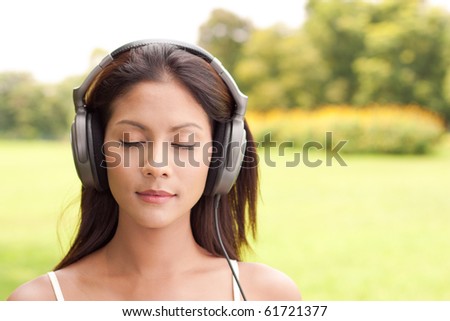 Young woman enjoying music with closed eyes