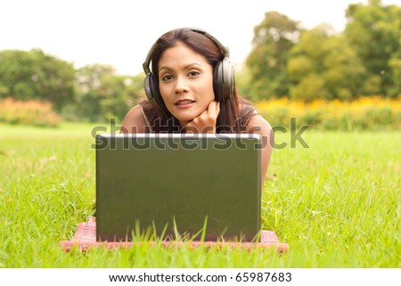 Young lady with laptop in park