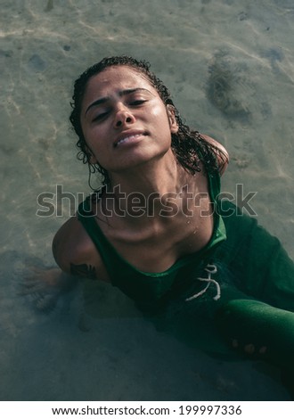 Female Model in Water Wearing Green Dress all wet.
