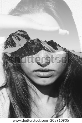 Double exposure portrait of attractive girl combined with photograph of snowy mountain