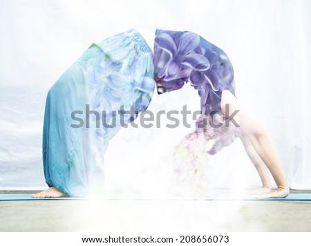 Double exposure portrait of young woman performing back bend combined with photograph of nature