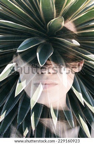Double exposure portrait of attractive woman covering her face with hair combined with photograph of cactus