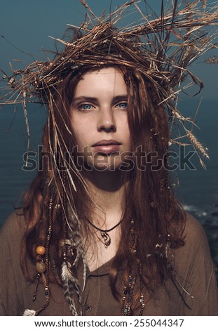 Close up Serious Pretty Young Woman in Boho Fashion with Long Brown Hair Wearing Head Wear Crown of Hay While Looking at the Camera.