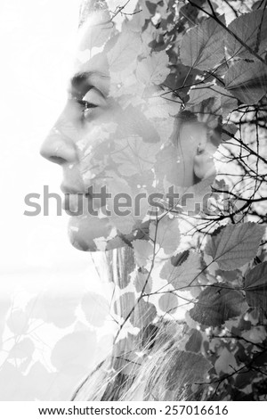 Double exposure of woman combined with photograph of leaves
