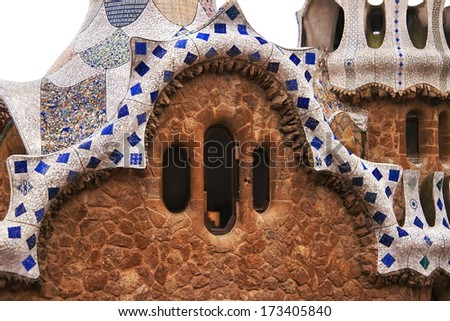 Ceramic mosaic of fairy tale house in Park Guell (Barcelona, Spain). Park Guell is the famous park by Antoni Gaudi, built in the 1900 to 1914 years. White background, cutout (isolated), close up.