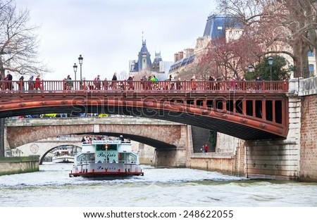 Paris, France - January 10, 2015. View of Seine river, boats (ships), bridge, people and coast (quay) in Paris in evening. Paris is the best destinations in Europe. Travel (vacation) concept.