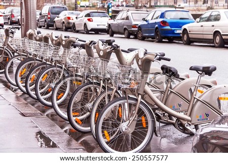 Paris, France - January 9, 2015. Bicycles. Velib bike rental service in Paris.  Convenient transport for people in the city near the cars. Travel, rental, transportation, healthy lifestyle concept.