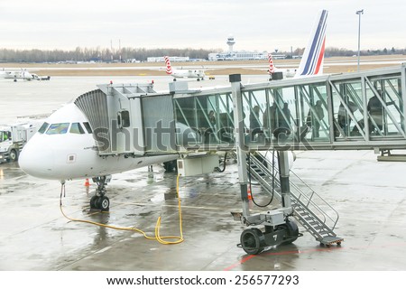 Warsaw, Poland - January 13, 2015: Airport passengers are go out of the plane at terminal gate. Disembarking of airplane. French national airline.