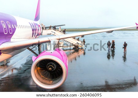 Paris (Beauvais), France - January 8, 2015: Airport passengers are go out of the plane at terminal. Wizzair is one of the largest low-cost  airline.