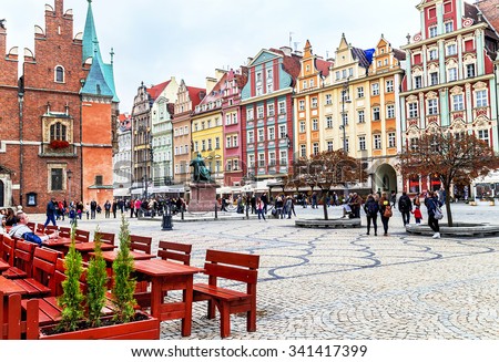 Wroclaw, Poland - October 17, 2015: People walking, resting on the famous, old market square in Wroclaw, Poland. Wroclaw is the historical capital of Silesia. Travel, vacation, arhitectura concept.