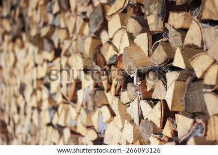 The woodpile. Village background. Village life. Preparing for winter. Blur and focus.