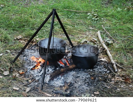 Preparing touristy food on campfire in wild camping