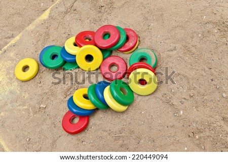 Toys to play with sand-pile of wooden colorful discs