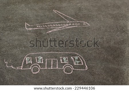Children\'s drawing of bus and plane made chalk on the paving