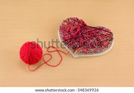 Panel of heart shaped made of thread and nails and clew of thread