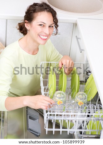 Dishwasher. Young woman in the Kitchen doing Housework. Wash-up