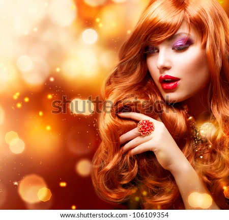 Golden Fashion Girl Portrait.Wavy Red Hair. Gold Blinking Background.Holiday