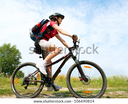 Happy Young Woman riding bicycle outside. Healthy Lifestyle.
