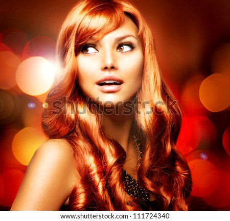 Beautiful Girl With Shiny Red Long Hair over Blinking Holiday Background.Surprised Woman
