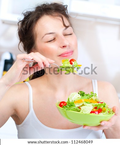 Diet.Beautiful Young Woman Eating Vegetable Salad .Dieting concept.Healthy Food