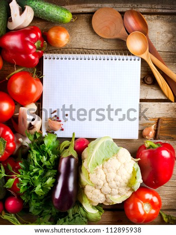 Fresh Organic Vegetables and Spices on a Wooden Background and Paper for Notes. Open Notebook and Fresh Vegetables Background.Diet.Dieting.Space For Your Text