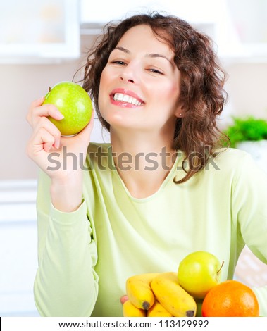 Diet. Happy Young Woman Eating Fresh Fruit. Dieting concept. Healthy Food. Vegan Food