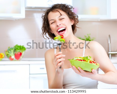 Diet. Happy Young Woman Eating Vegetable Salad. Dieting concept.Healthy Food . Vegan Food