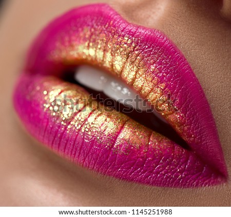 Lips make-up. Beauty high fashion trendy gradient lips makeup sample, purple with golden color, sexy mouth closeup. Lipstick. Professional Make up artist work