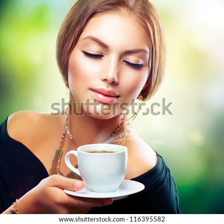 Tea. Beautiful Girl Drinking Tea or Coffee. Healthy Beverage. Woman with Cup over Nature Green Background