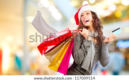 Christmas Shopping. Beautiful Happy Girl With Credit Card In Shopping Mall. Shopping Bags. Shopping Center. Christmas Sales