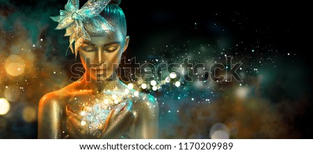 High Fashion model woman in colorful bright golden sparkles and neon lights posing with fantasy flower, portrait of beautiful girl glowing make-up. Art design colorful make up. Glitter Vivid neon skin