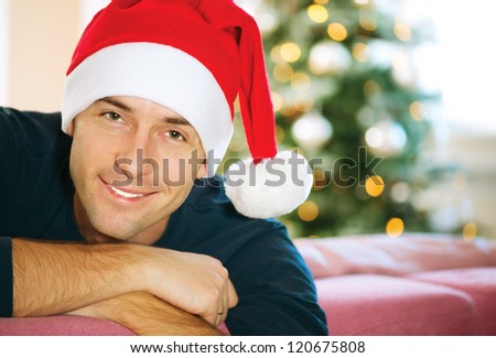 Handsome Young Man wearing Santa\'s Hat. Christmas Guy Portrait