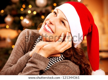 Christmas Woman.Happy Surprised Girl at home. Christmas Wishes