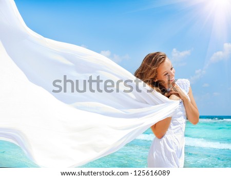 Beautiful Girl With White Scarf on The Beach. Travel and Vacation.