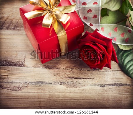 Valentine. Valentines Rose Flower and Gift Box over Wooden Background. Red Valentine\'s Day Border Art Design on Wood