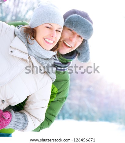 Happy Couple Having Fun Outdoors. Snow. Winter Vacation. Outdoor