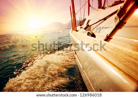 Yacht Sailing Against Sunset. Sailboat. Yachting. Sailing. Travel Concept. Vacation