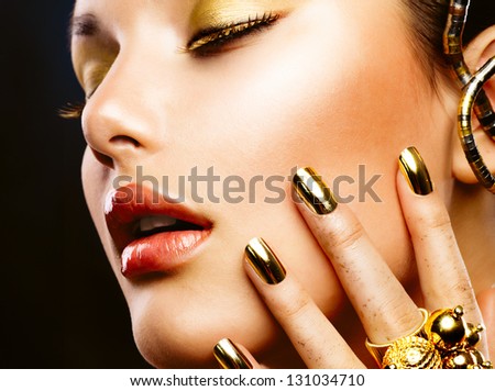 Fashion Girl Portrait. Gold Makeup. Golden Nails And Eyeshadows. Golden Make-Up And Nailpolish