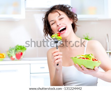 Diet. Beautiful Young Woman Eating Vegetable Salad. Dieting concept. Healthy Food