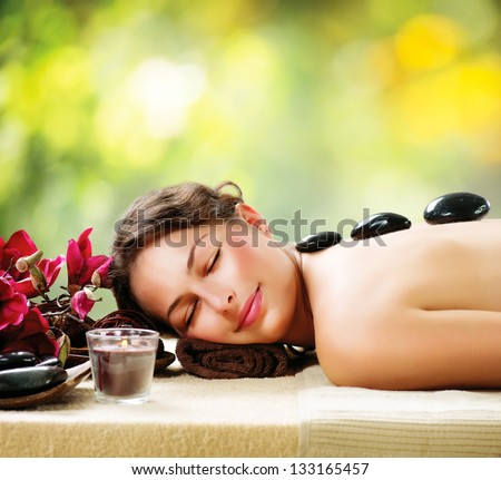 Spa Stone Massage Beautiful Woman Getting Spa Hot Stones Massage in Spa Salon Beauty Treatments Outdoor Nature Spa Stone Massage Beautiful Woman Getting Spa Hot Stones Massage in Spa Salon Beauty Treatments Outdoor Nature