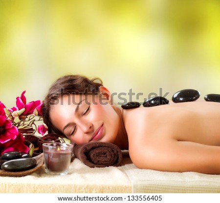 Spa Stone Massage. Beautiful Woman Getting Spa Hot Stones Massage in Spa Salon. Beauty Treatments Outdoor. Nature