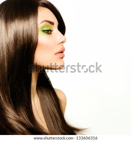 Hair. Beautiful Brunette Girl. Healthy Long Brown Hair. Beauty Model Woman With Green Makeup. Trendy Spring Make-Up