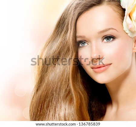 Beauty Girl. Beautiful Model Face. Healthy Long Hair and Perfect Clear Skin. Youth. Isolated on White Background. Skincare concept